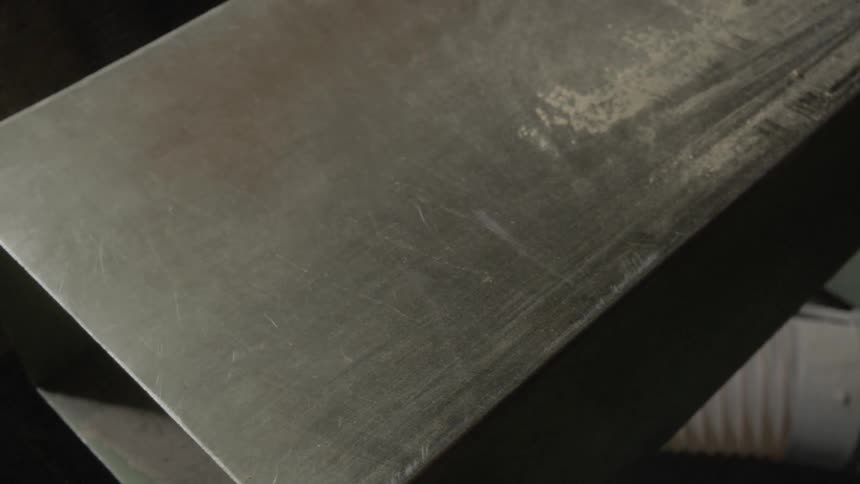 Dust being blown off a hollow steel bar