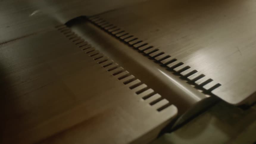 A person that is cutting some wood on a table saw