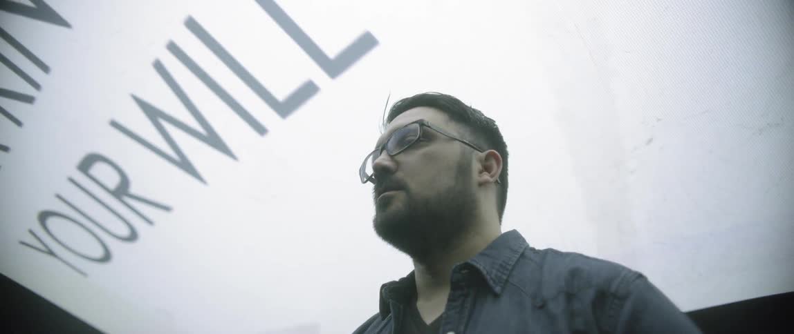 Man standing under a massive display