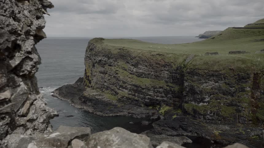 A structure constructed from stones on a high cliff above the sea
