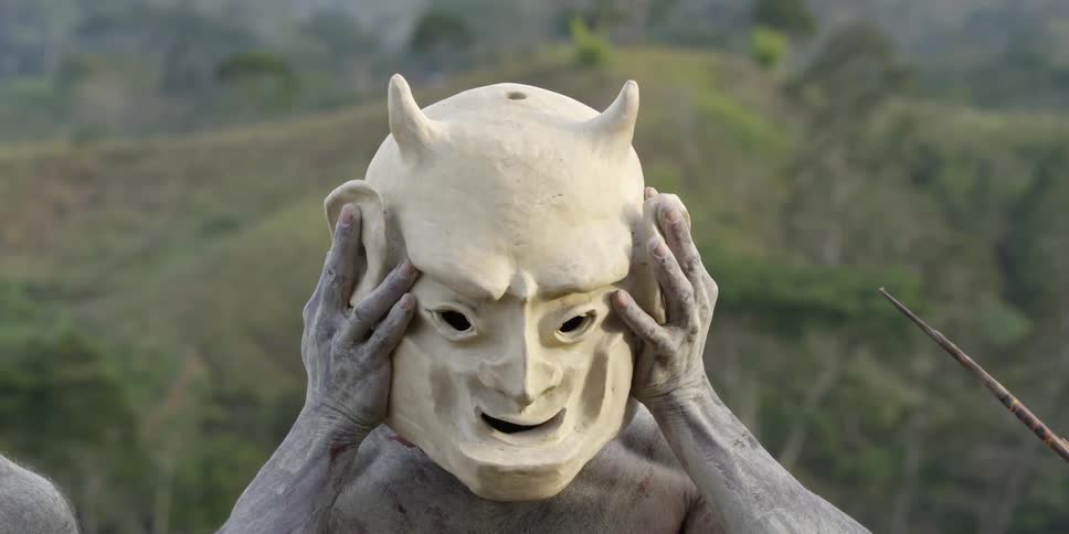 A man is putting a mask on