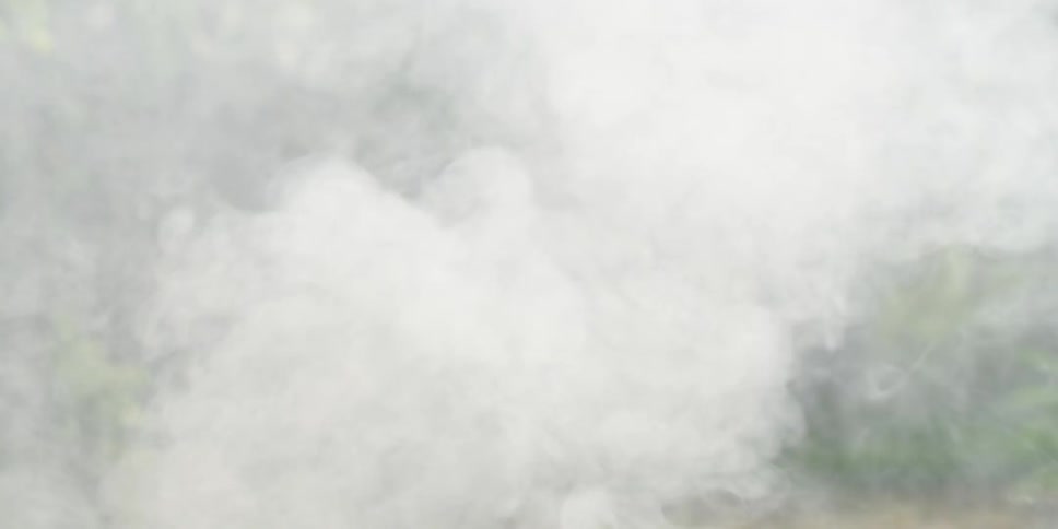 Smoke rises from an outdoor cooking pot