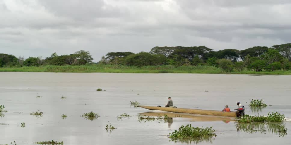 People sitting on a boat on a river