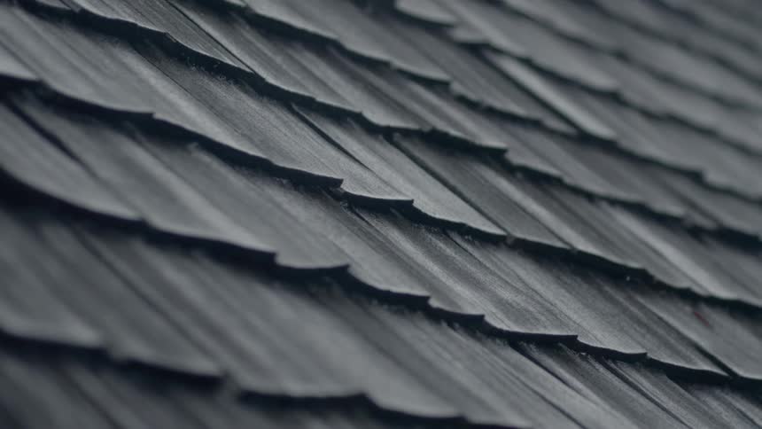 Rain falls on a split board roof