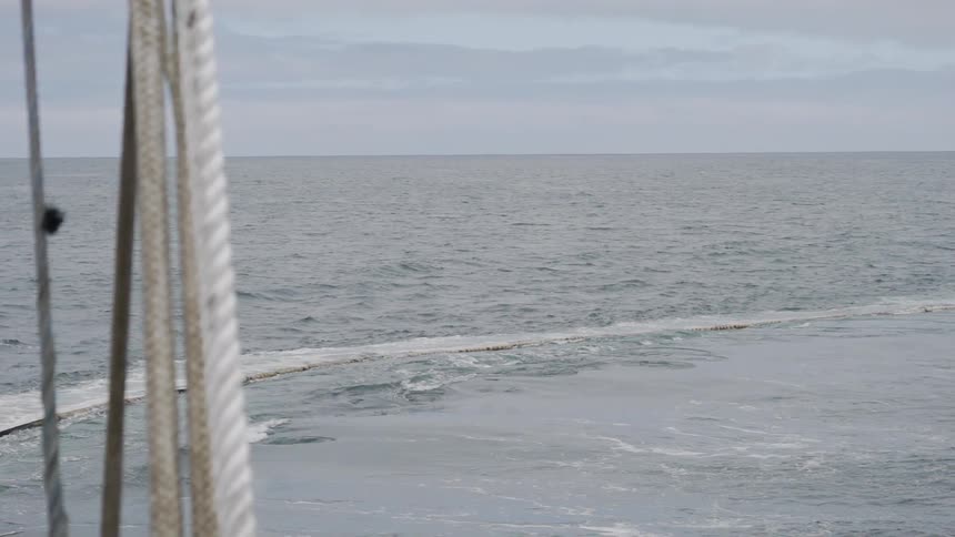 Waves crashing over a rock wall in the ocean