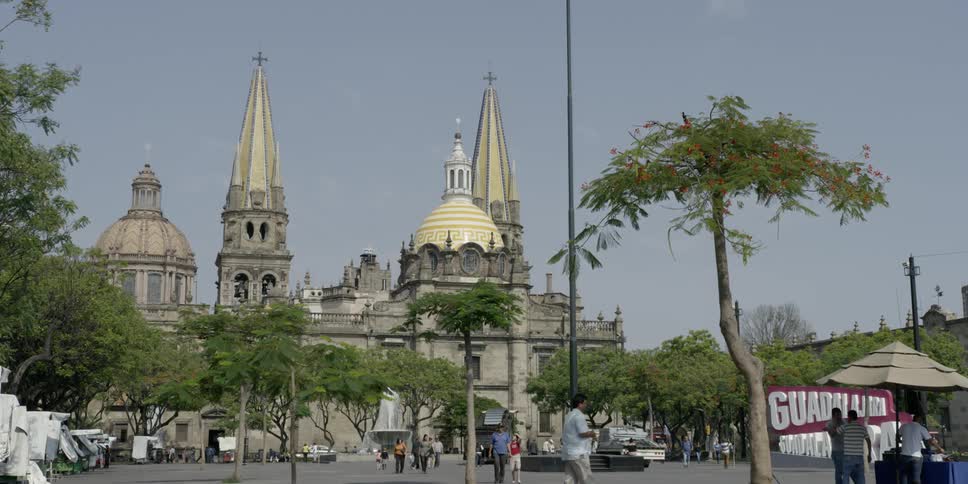 Pedestrians walk near church in guadalajara