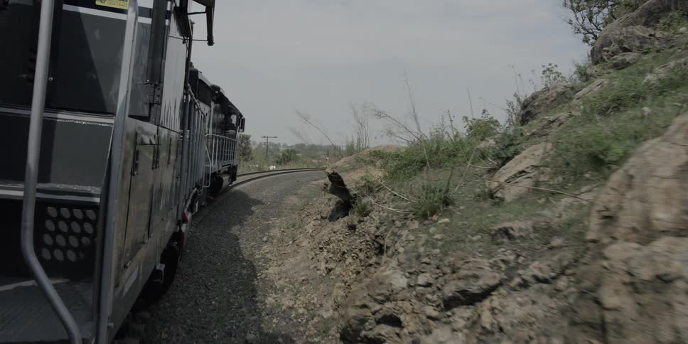 A train moves slowly down train tracks