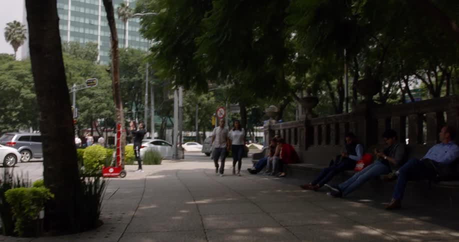 A couple is walking down the sidewalk together