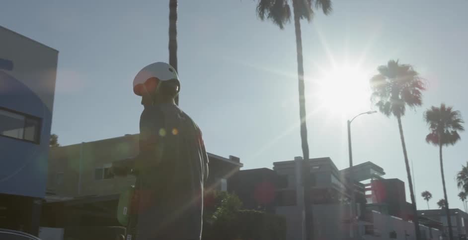 Man rides near palm trees