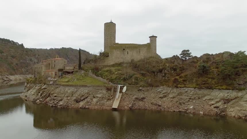 Old building on the edge of a cape projecting into a river