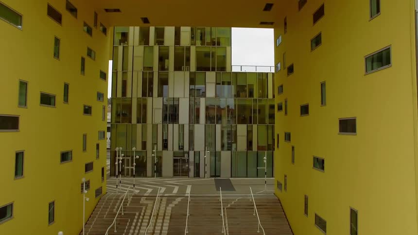 Yellow corridor facing building with variable window placements