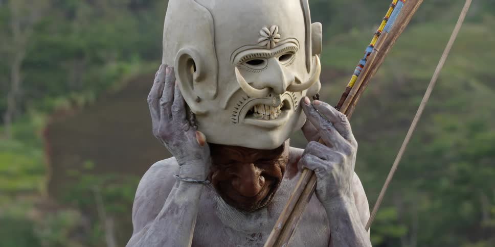 A man holds a mask