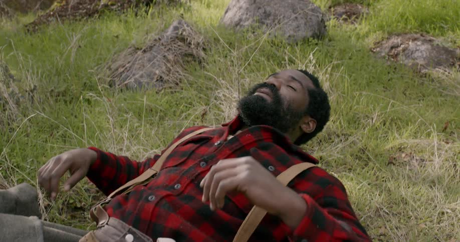 A man laying on grass