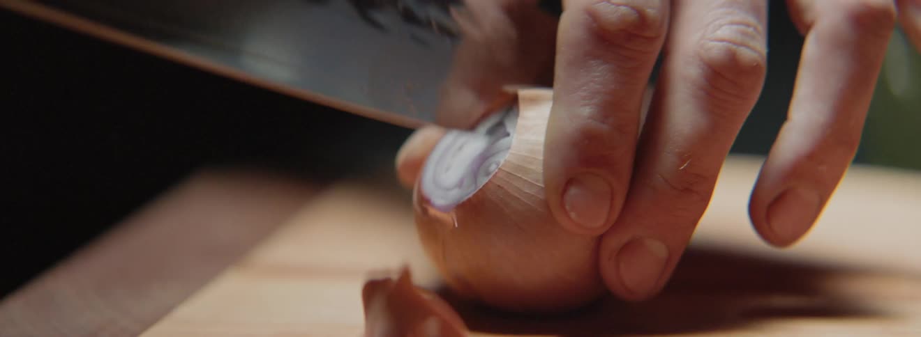 A man cutting an onion