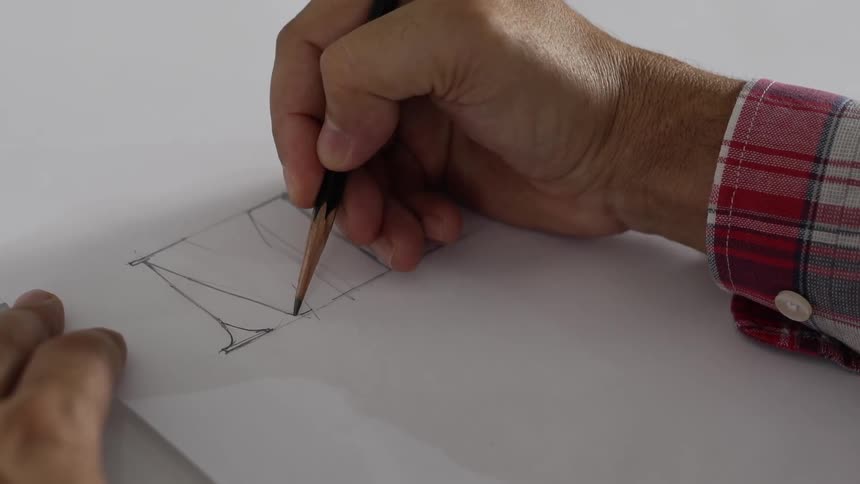 Artist outlines letters on white paper