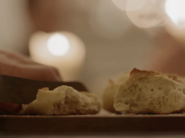 Bread being sliced with a knife