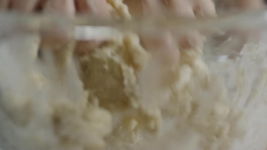 A kid mixing a bowl of sticky dough