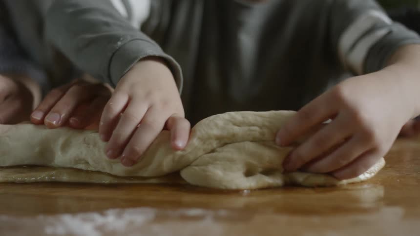 Children roll up dough