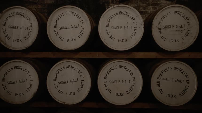Barrels sit on shelves in a room