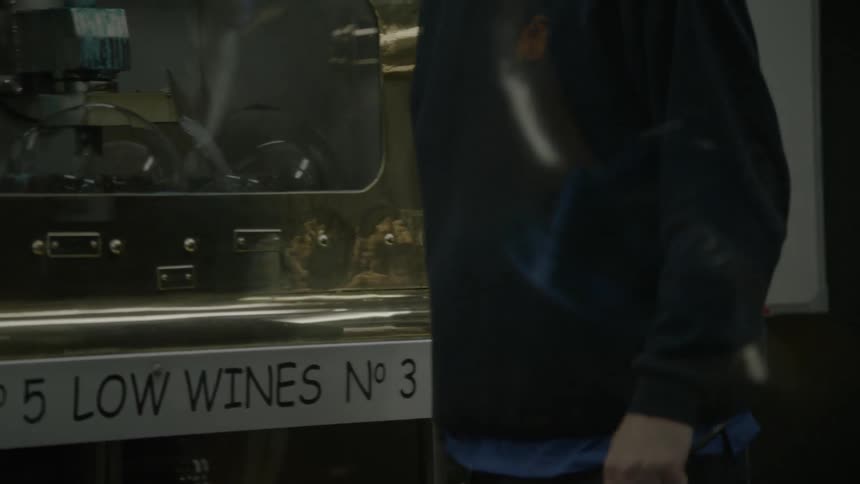 Person walks along wine related machinery