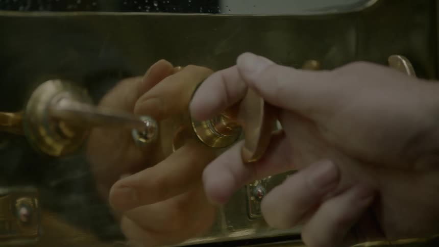A person is turning the valve on the machine