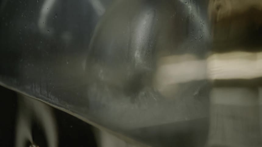 Water flows into a glass container