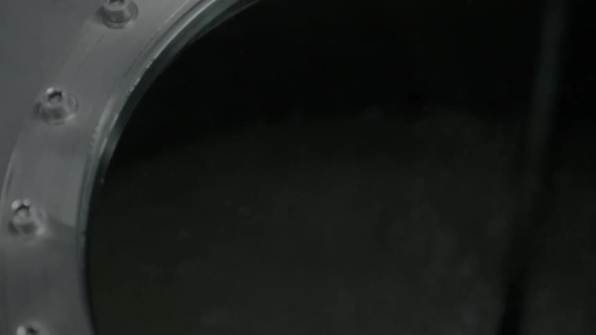 Nuts and bolts around the stainless steel round window into a tank