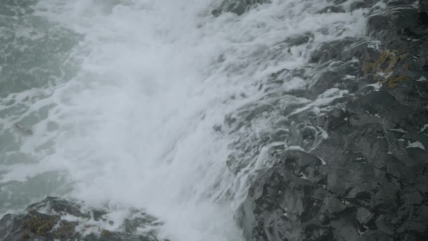 Waves crash against rock