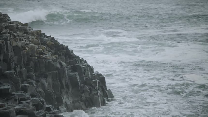 Waves crash against rock on the shoreline