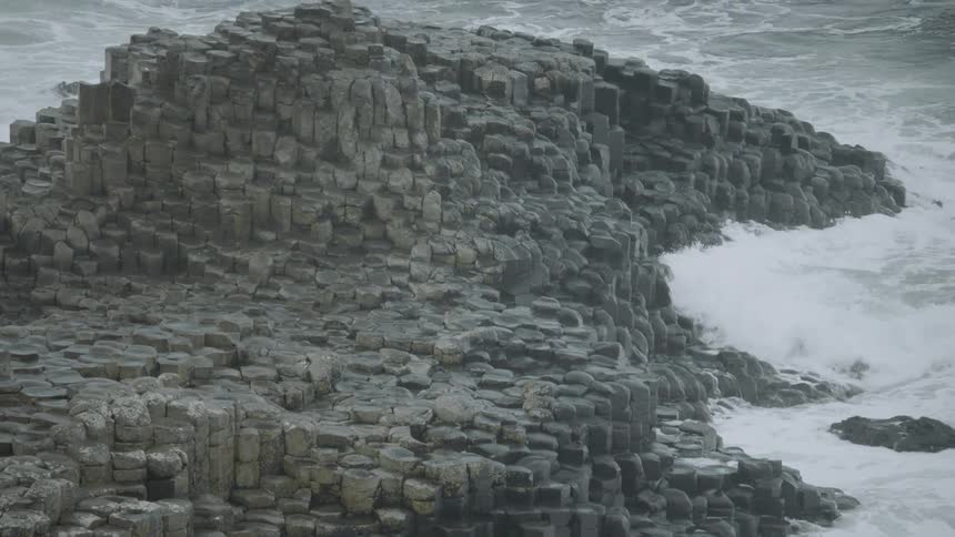 Waves crash up against rocks
