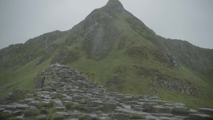 A large peak rises above rocks