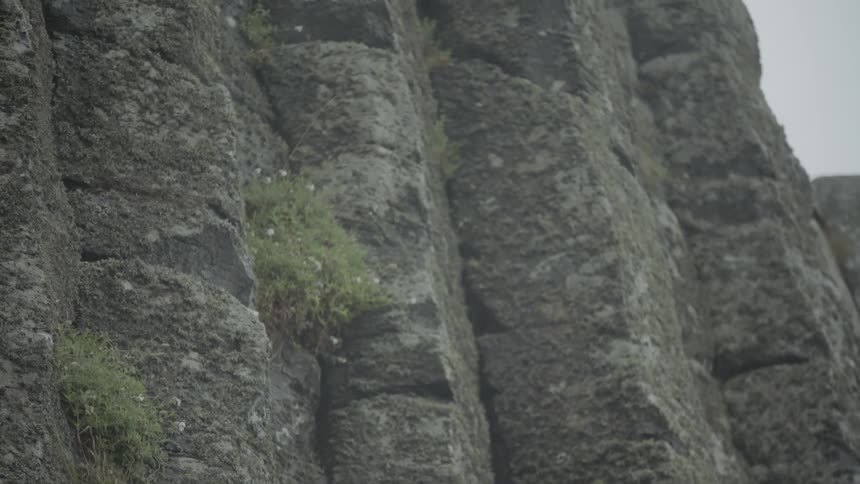 Heavy clouds are over the tall cliff