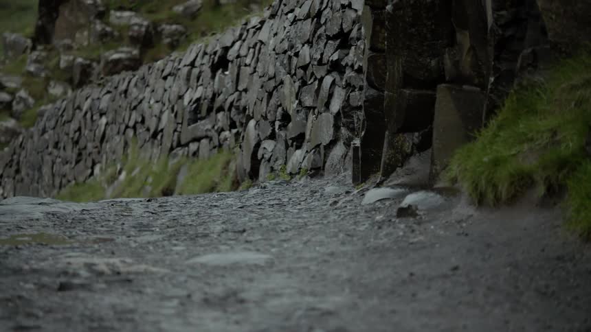 The wall on the trail is made of stones