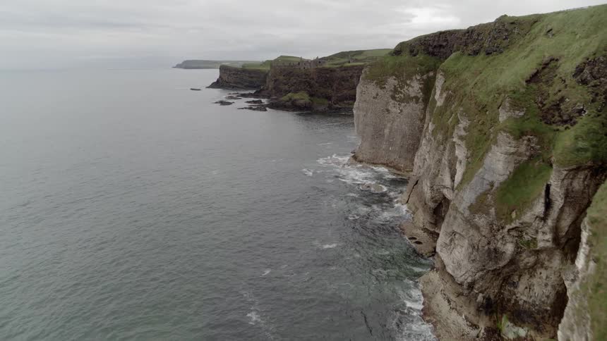 An aerial view of cliffs bordering an ocean