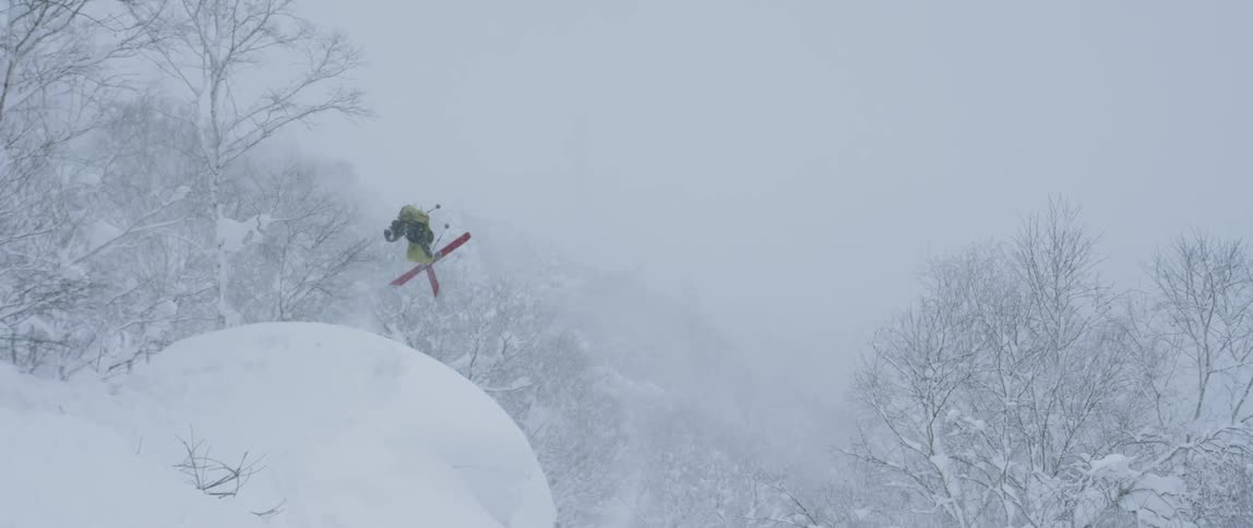 A skier jumps off a rounded slope