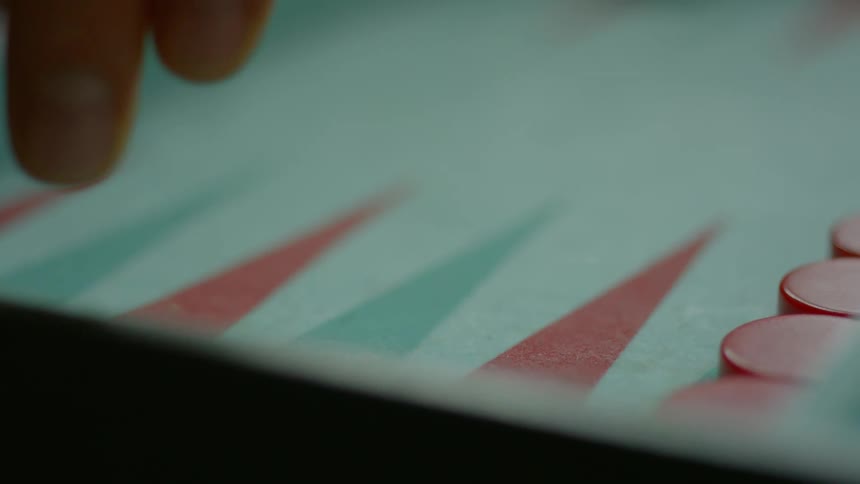 A person is playing backgammon