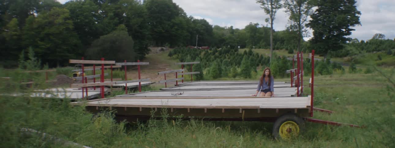 A woman is sitting on a trailer