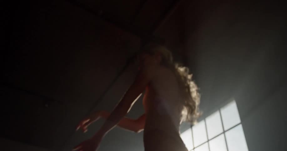 Ballet dancer dances in dark room