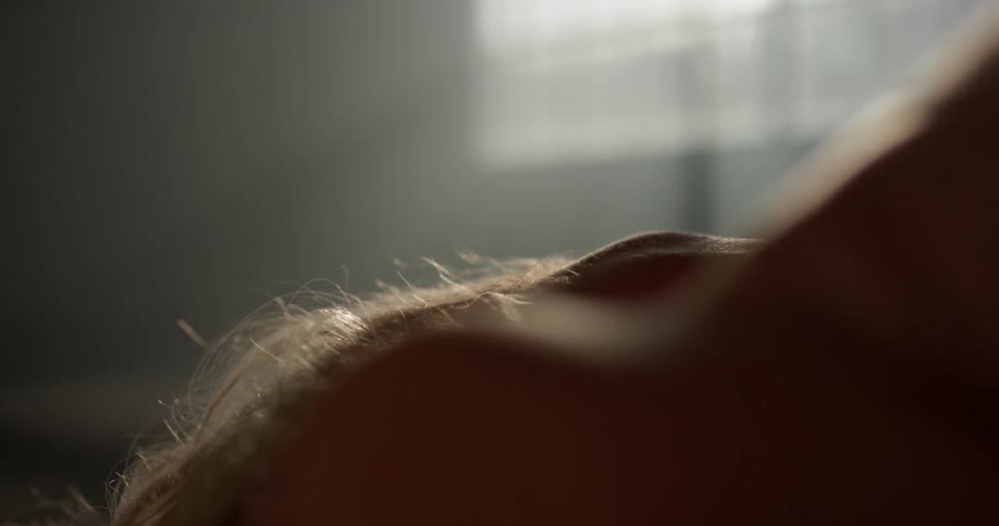 A woman writhes on the floor
