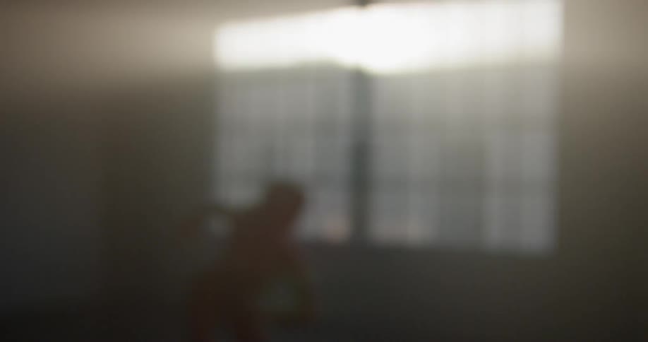 A woman dances by herself in a large empty room