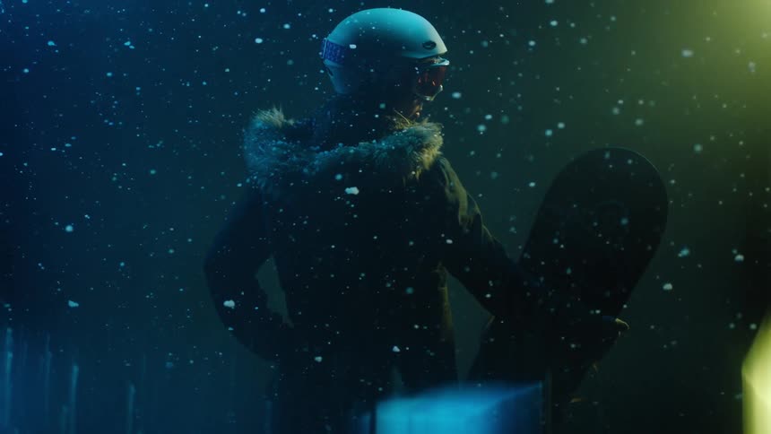 A person wearing a helmet and holding a snowboard