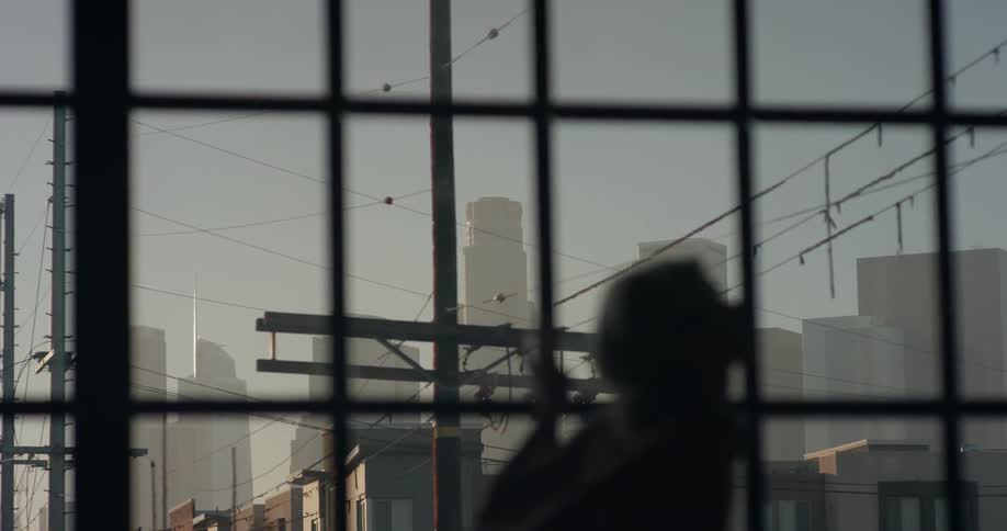 A female dancer rehearses in front of a window in an urban dance studio
