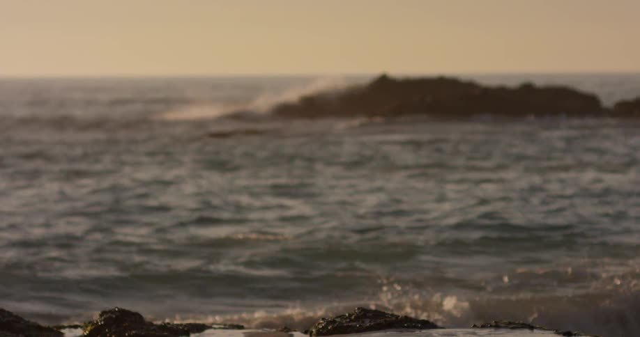 Waves crashagainst the shore at sunset