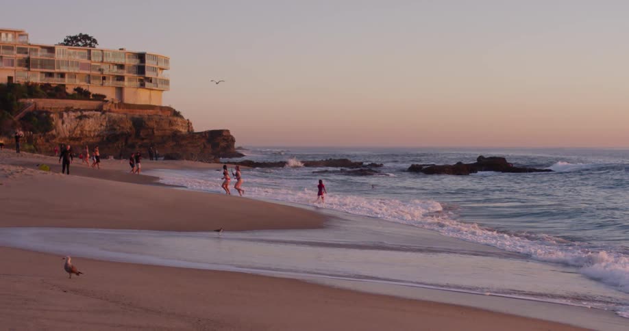 People on the beach with buildings and the sky in the background