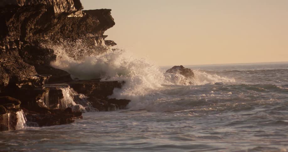 Rough ocean water crashes over the rocks