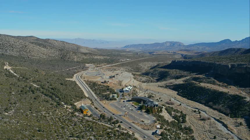 A road with mountains and the sky in the background