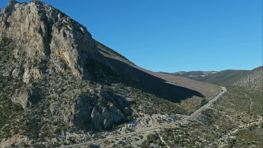 Mountainous area with a highway passing through it on a clear day