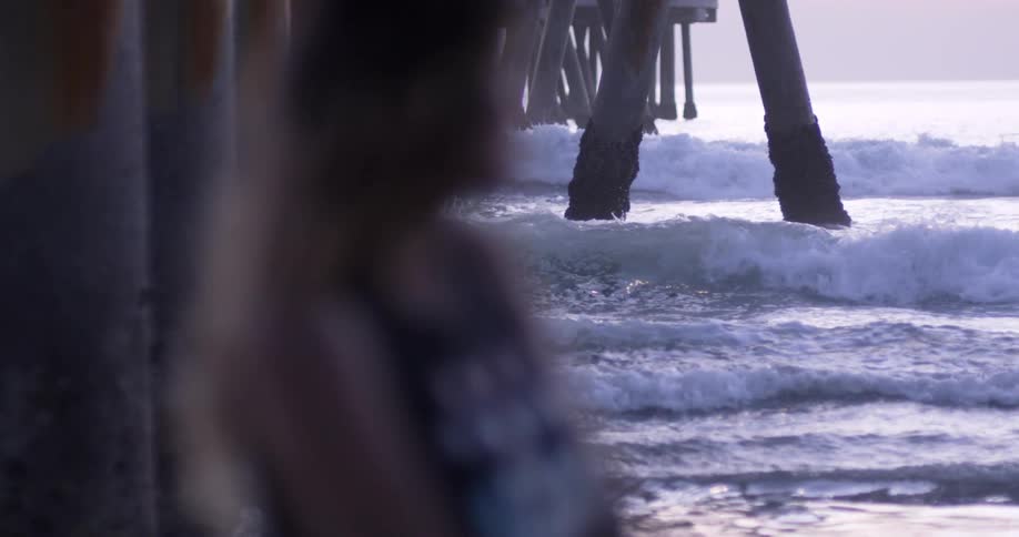 Man rides a surfboard over the ocean waves
