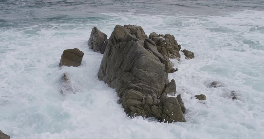 Ocean waves crash over the rocks