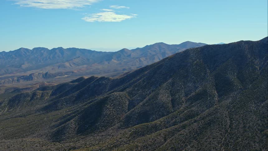 A mountain range under a blue sky